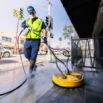 a man in a yellow vest is cleaning a street