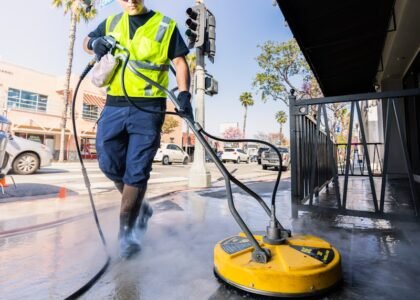 a man in a yellow vest is cleaning a street